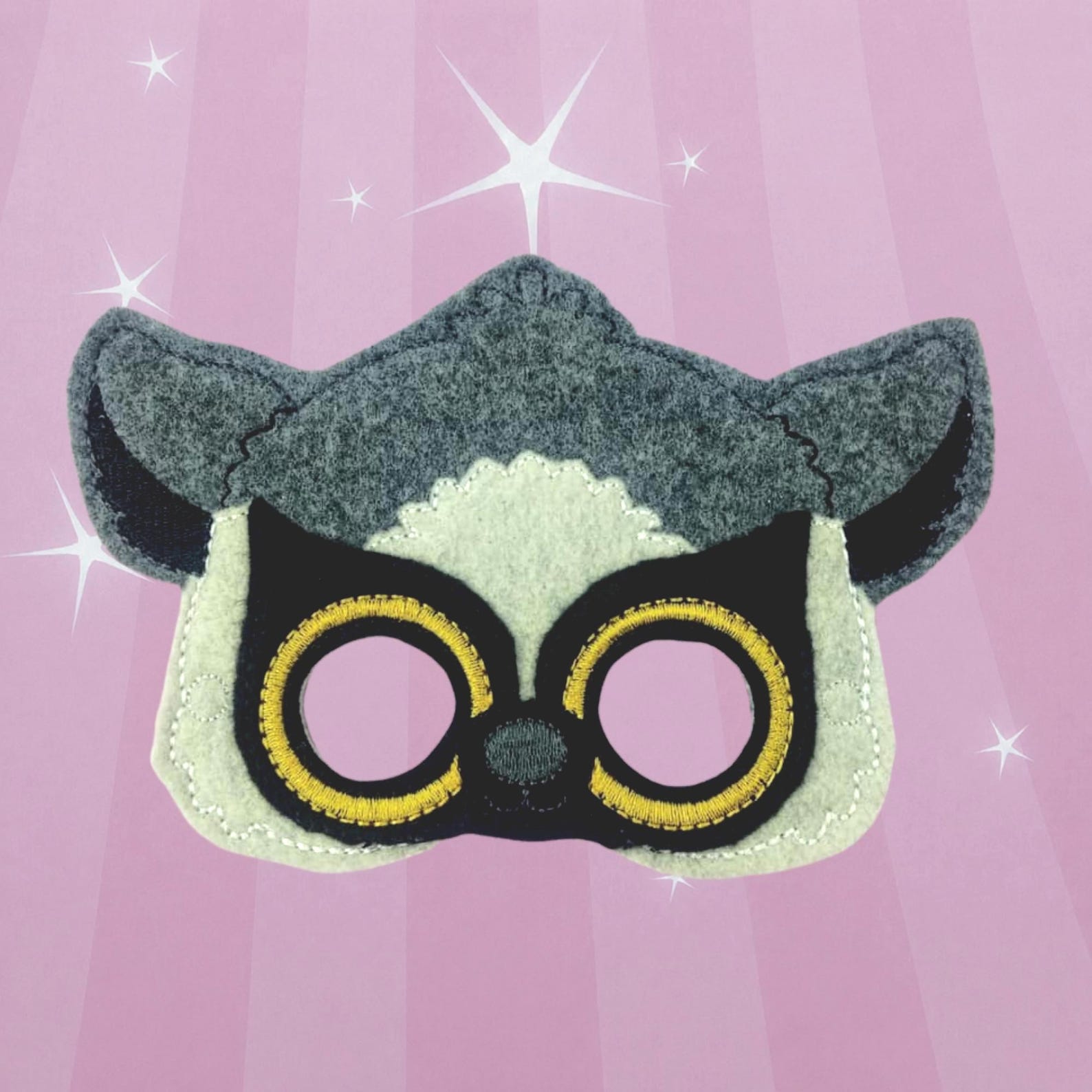 Gray felt lemur mask with pale yellow and black eye circles.