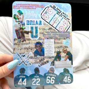 May include: A rectangular holographic sticker sheet featuring a collage of hockey-themed imagery, including the text Briar U, Logan, and various player names with jersey numbers 44, 22, 66, and 46, alongside musical notation and quotes.