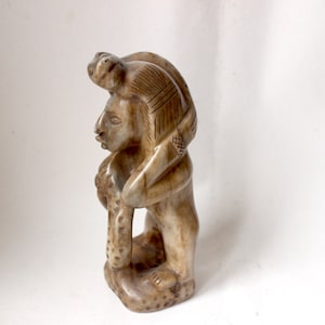 Vintage carved soapstone statue representing a Mayan / Aztec warrior or priest with a snake python.