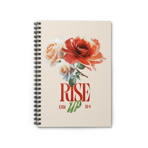 May include: A spiral-bound notebook with a cream-colored cover featuring a cluster of red and white roses at the top. Below the flowers, the text reads "RISE UP" in large red letters, with "EZRA 10:4" printed in smaller red text underneath.