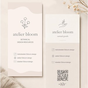 May include: Two rectangular business cards in beige and white. The left card features a flower icon, the text atelier bloom, BOTANICAL DESIGN RESOURCES, and contact details. The right card shows a hand icon, atelier bloom, natural goods, contact details, a QR code, and a leaf icon.