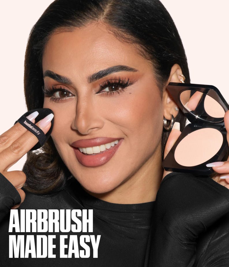 May include: A black square compact containing light beige pressed powder with an attached mirror, paired with a black circular powder puff featuring the text hudabeauty. The text AIRBRUSH MADE EASY is displayed in white at the bottom of the image.
