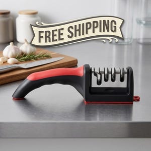 May include: A handheld knife sharpener featuring a black and red ergonomic handle and a multi-slot sharpening mechanism. The device has a sturdy base and a small circular loop at the end for storage, designed for maintaining kitchen cutlery edges.