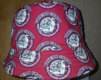 May include: Red bucket hat with a white bulldog logo that says "Toledo Scott Once a Bulldog Always a Bulldog".
