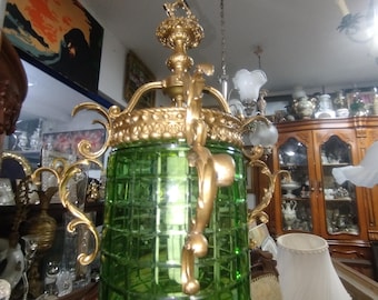 Vintage green glass pendant lantern housed in an ornate brass or bronze frame