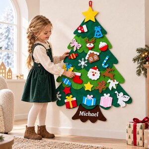 May include: A wall-hanging felt Christmas tree featuring a yellow star topper and various colorful felt ornaments including a Santa Claus, gingerbread man, reindeer, gifts, and candy. The brown tree trunk is personalized with the name Michael.