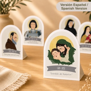 May include: A collection of arched, freestanding paper cards featuring illustrations of religious figures with halos. The front card depicts San José holding a child, with the text 'SAN JOSÉ' and 'Guardián del Redentor.' printed on a grey banner.