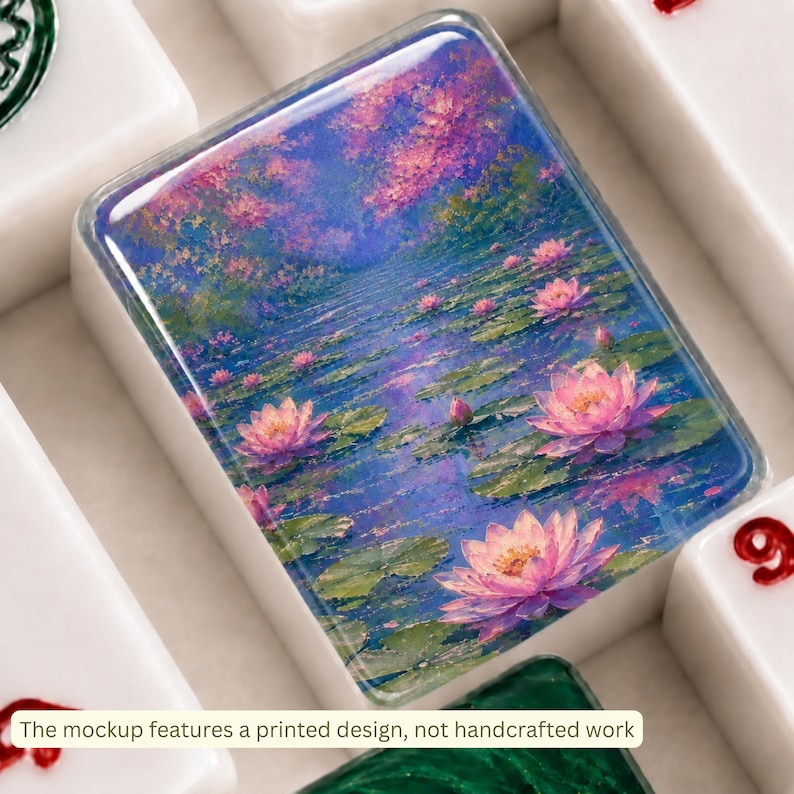 May include: A rectangular white tile featuring a vibrant, painterly print of pink lotus flowers floating on a deep blue pond with green lily pads. The surface is glossy and smooth, surrounded by other white tiles with red and green markings.