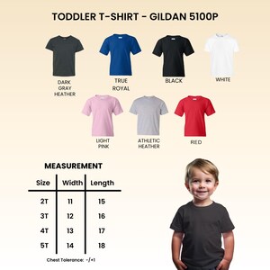 May include: A collection of Gildan 5100P toddler t-shirts in dark gray heather, true royal, black, white, light pink, athletic heather, and red. A measurement chart lists sizes 2T through 5T with widths of 11 to 14 inches and lengths of 15 to 18 inches.