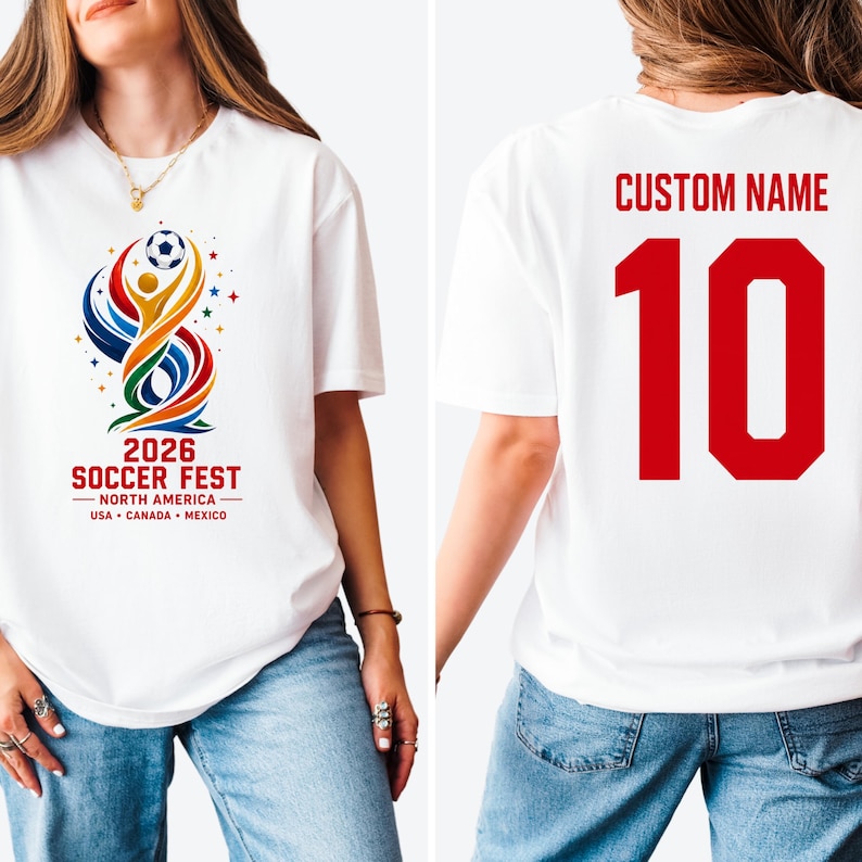 May include: A white t-shirt featuring a colorful graphic on the front with a soccer ball, abstract shapes, and the text 2026 SOCCER FEST NORTH AMERICA USA CANADA MEXICO. The back displays the text CUSTOM NAME above the large red number 10.