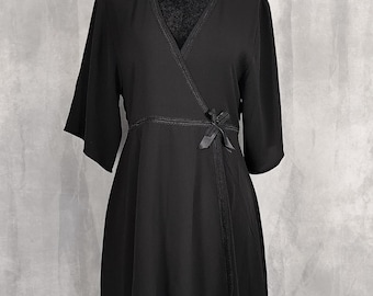 May include: A black wrap dress featuring a V-neckline, elbow-length sleeves, and a decorative ribbon tie at the waist. The garment includes detailed stitching along the neckline and waistline, with a flowing skirt that falls above the knee.