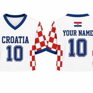 May include: A white V-neck crop top jersey with red and white checkered sleeves and side panels. The front features the blue text CROATIA and the number 10. The back displays the text YOUR NAME, the number 10, and a small Croatian flag.