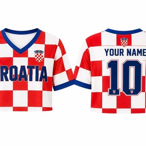 May include: A cropped V-neck jersey featuring a red and white checkered pattern with blue trim. The front displays the text CROATIA and a small crest. The back shows the text YOUR NAME above the number 10, with a small crest above the name.