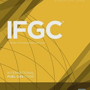 May include: A 2018 International Fuel Gas Code book with a yellow cover featuring dark brown diagonal stripes and thin white curved lines. The text IFGC is printed in large white letters, with the American Gas Association and ICC logos below.