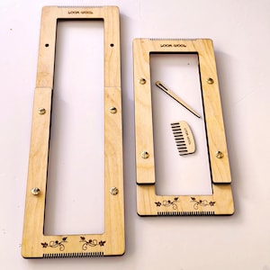May include: Two wooden weaving looms with the text "LOOM-WOOL" and a small comb and needle. The looms are rectangular with decorative floral designs and metal screws. The looms are made of light-colored wood.
