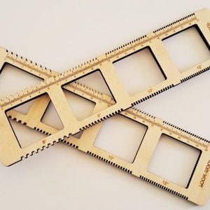 May include: Two wooden rulers with square cutouts and inch markings. The rulers are labelled "loom + wood".