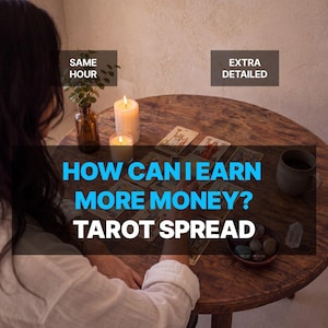 May include: A round wooden table features a tarot card spread with the text "HOW CAN I EARN MORE MONEY? TAROT SPREAD", "SAME HOUR", and "EXTRA DETAILED". Two lit candles, a small plant in a glass vase, a ceramic mug, and a bowl of stones are present.