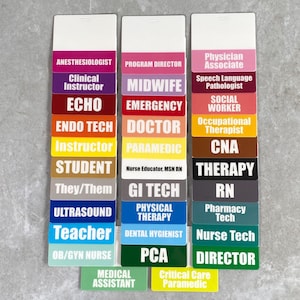 May include: A set of colorful name tags with various medical and healthcare job titles printed on them. The tags are arranged in three columns, with each column representing a different category of healthcare professional. The categories are: Anesthesiologist, Program Director, and Physician Associate. The tags are made of a durable plastic material and are designed to be easily attached to clothing.