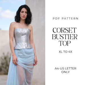 May include: A PDF pattern for a corset bustier top in sizes XL to 4X, formatted for A4 and US letter paper. The garment features a metallic silver strapless bodice with vertical seams paired with a sheer, light blue draped skirt overlay.