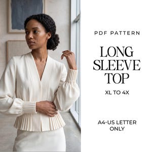 Può includere: Un cartamodello in PDF per un top a maniche lunghe nelle taglie da XL a 4X, formattato per carta A4 e US letter. Il top è color crema con scollo a V, maniche lunghe con polsini a coste e un orlo a baschina plissettato in vita.