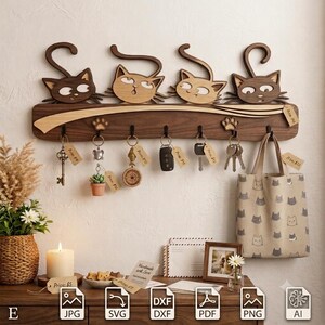 May include: A wall-mounted wooden key holder featuring four carved cat heads with curled tails along the top edge. The dark wood board includes six black metal hooks, each holding various keys, keychains, and a small beige tote bag.