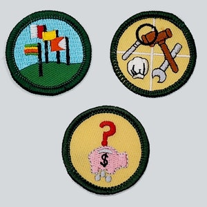 May include: Three embroidered patches with green borders. The first patch has a blue background with a green field and three flags with red, yellow, and blue colors. The second patch has a yellow background with a white cross and a red hammer, a white wrench, and a white pipe wrench. The third patch has a yellow background with a red question mark and a pink piggy bank with a dollar sign.