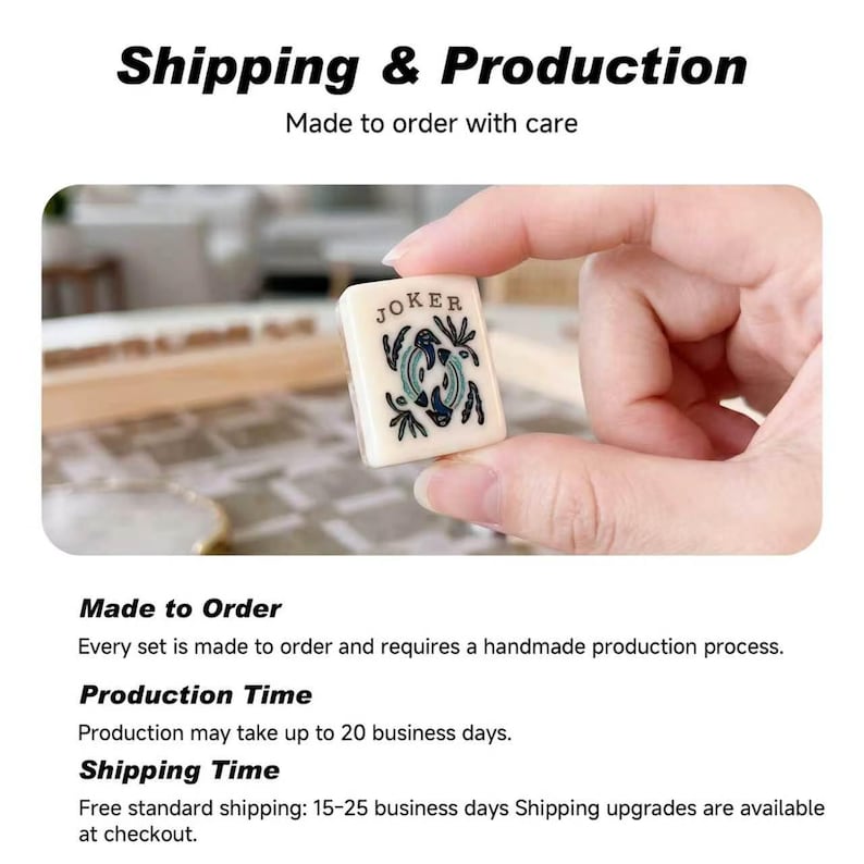 May include: A rectangular off-white mahjong tile featuring the word JOKER printed in black at the top, with a central graphic illustration of two stylized fish in shades of blue and green, surrounded by small black leaf-like decorative accents.