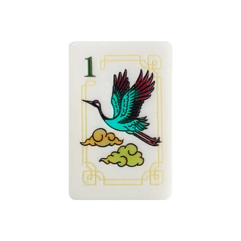 May include: A rectangular white mahjong tile featuring the number 1 in green at the top left corner. The center displays a flying crane with teal and dark red wings, positioned above two stylized yellow and light green clouds within a thin border.