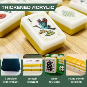 May include: A set of thickened acrylic mahjong tiles featuring white tops with colorful engraved designs, including a crane and dragon, and solid yellow bases. The set includes a black storage box, scratch-resistant surfaces, and rounded corners.