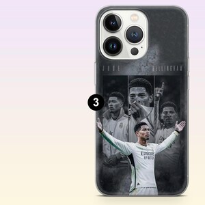 May include: A clear smartphone case featuring a collage of Jude Bellingham in a white soccer jersey. The design includes three distinct portraits of the athlete and the text JUDE BELLINGHAM printed at the top. The case has a camera cutout.