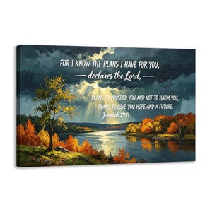 May include: A rectangular wall art print featuring a landscape painting of a river at sunset with orange and yellow autumn trees. The sky is dark with storm clouds and light rays. Text reads: FOR I KNOW THE PLANS I HAVE FOR YOU, declares the Lord, PLANS TO PROSPER YOU AND NOT TO HARM YOU, PLANS TO GIVE YOU HOPE AND A FUTURE. Jeremiah 29:11