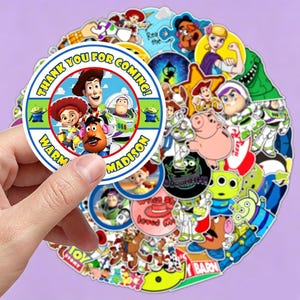 May include: A circular sticker featuring Toy Story characters including Woody, Jessie, Buzz Lightyear, and Mr. Potato Head. The text reads THANK YOU FOR COMING! and WARM MADISON. The sticker is surrounded by a collection of various Toy Story themed stickers.