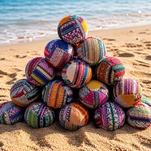 May include: A pyramid stack of spherical juggling balls made from various colorful fabric patches. Each ball features a unique combination of striped, floral, and geometric patterns in vibrant hues including yellow, blue, pink, and green.