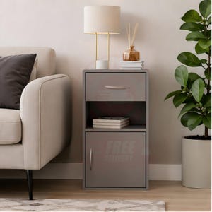 May include: A grey bedside table featuring a single top drawer with a silver handle, an open middle storage shelf, and a bottom cabinet with a silver handle. The unit has a rectangular frame and a smooth finish, providing storage space for books.