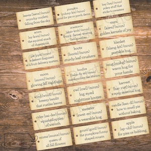 May include: A collection of vintage-style tags with autumn-themed words and phrases like "leaves," "pumpkin," and "harvest." The tags are arranged on a wooden surface, evoking a rustic, seasonal aesthetic.