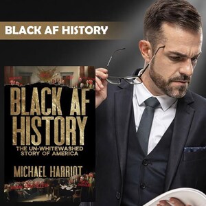 May include: A book titled Black AF History: The Un-Whitewashed Story of America by Michael Harriot. The cover features gold text on a black background with historical imagery. A person in a dark suit and tie holds glasses near their face.