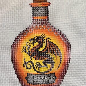 May include: A glass bottle with a cork stopper and a dragon design. The bottle is filled with a liquid that appears to be orange and yellow. The bottle has a label that reads "Dragon's Breath".
