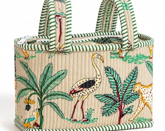 May include: A rectangular quilted bag featuring a beige base with a colorful print of flamingos, leopards, and tropical plants. The bag has two padded handles and a top zipper closure, all accented with a green and white striped fabric trim.