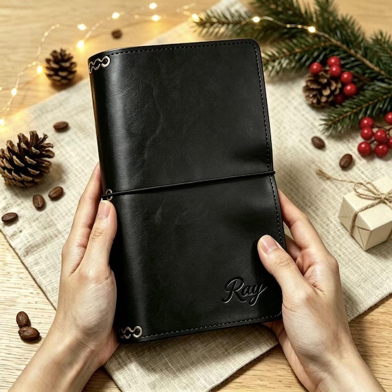 A hand-stitched vegan leather A5 journal cover with custom monogramming — a tactile, desk-worthy gift that feels genuinely crafted rather than printed.