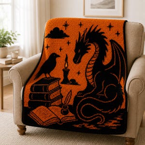 May include: A rectangular crochet blanket featuring a vibrant orange background with a black graphic design. The pattern depicts a large dragon, a raven perched on a stack of three books, an open book with an inkwell and quill, and a lit candle.