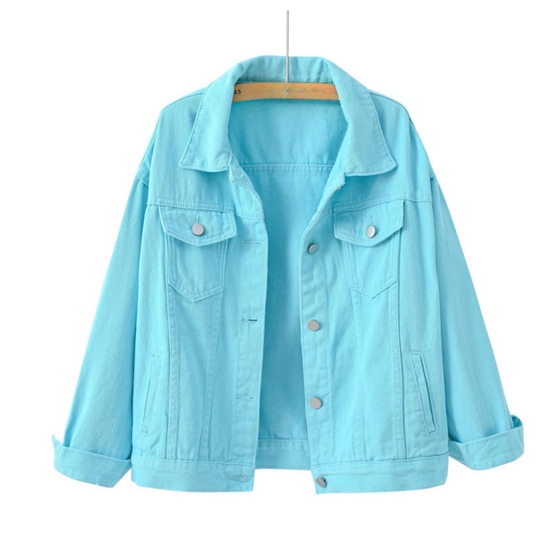 May include: A bright turquoise denim jacket featuring a classic collar, long sleeves with folded cuffs, two chest pockets with button flaps, and a front button closure. The jacket is constructed with visible seams and silver-toned metal buttons.
