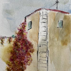 May include: A watercolor painting of a tan building corner with a red roof, featuring a large climbing plant with pink and red flowers on the left side, two small windows, and a dark antenna on the roof against a light blue and gray sky.