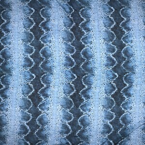 May include: A fabric featuring a repeating snakeskin pattern in shades of light blue, medium blue, and dark navy. The design consists of vertical bands of textured, scale-like shapes that create a continuous, interconnected visual effect across the surface.