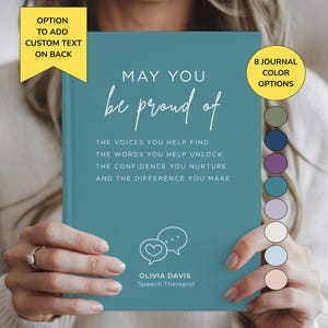 May include: A teal journal with white text that reads: MAY YOU be proud of THE VOICES YOU HELP FIND THE WORDS YOU HELP UNLOCK THE CONFIDENCE YOU NURTURE AND THE DIFFERENCE YOU MAKE. Below is a speech bubble icon, OLIVIA DAVIS, and Speech Therapist.