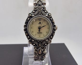 A vintage elegance Ladies stunning cocktail quartz watch from the "Marcasite Collection" (Model MAC02 R.C.).