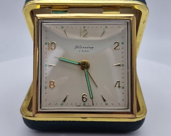 This charming vintage Blessing travel alarm clock features a classic mid-century design, proudly crafted in West Germany.
