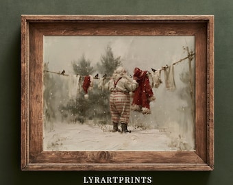 May include: A framed art print featuring a figure in a red and white striped outfit hanging laundry on a clothesline in a snowy landscape with pine trees. The text LYRARTPRINTS is visible at the bottom. The frame is made of brown wood.