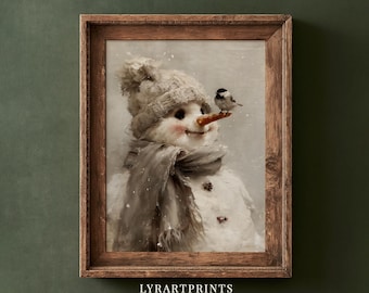 May include: A framed wall art print featuring a snowman wearing a gray knit hat and a matching scarf. The snowman has a carrot nose with a small black and white bird perched on it. The artwork is enclosed in a rustic brown wooden frame.