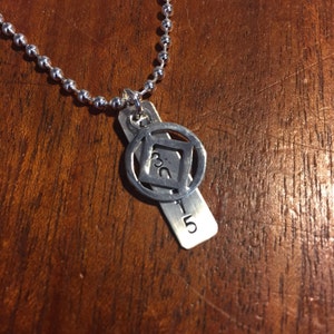 Sterling silver tag hand stamped with date. Sterling Silver NA symbol or Silver AA symbol