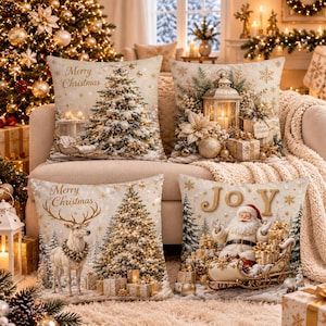 May include: Four square scatter cushions featuring Christmas themes. One shows a snowy tree with Merry Christmas text, another a lantern and poinsettias, a third a reindeer by a tree with Merry Christmas text, and the fourth Santa in a sleigh with Joy text.